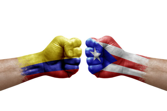 Two hands punch to each others on white background. Country flags painted fists, conflict crisis concept between colombia and puerto rico