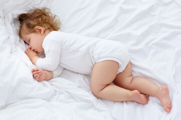 Obraz na płótnie Canvas Peaceful sleep. An adorable baby sleeping on the bed.