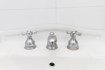 gray iron faucet, on a white sink in Rio de Janeiro