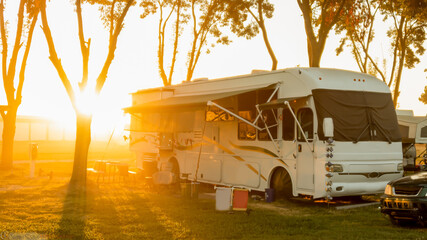 Rv Camping with sun rising or setting behind motorhome