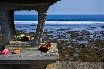 dried flowers that are an offering, to a temple by the sea