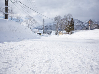 empty snow-covered street and wheel trucks in nagano
