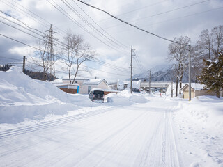 empty snow-covered street and wheel trucks in nagano