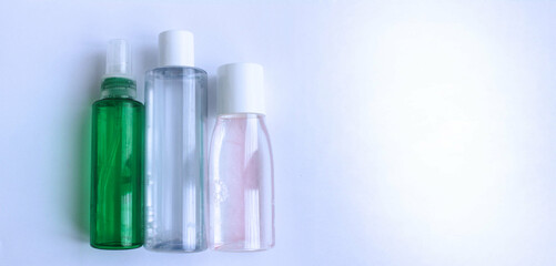 Three transparent bubbles: green, blue, pink on a white background.