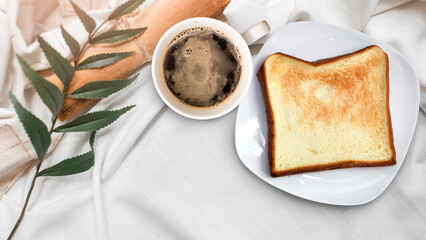 Diet set, a plate of one toast with a cup of black coffee, top view