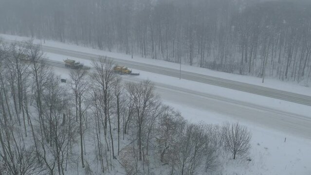 Convoy Of Snow Plow Trucks Clearing Highway In Mississauga, Canada. High Angle Pan Right View