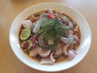 Yum Kung Fresh Thai food with spicy sauce. Followed by sour, sweet, salty. It is a popular food of Thai people. Topped with a bunch of seaweed