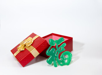 Red christmas gift box with Ribbon, fortune in Chinese, white background