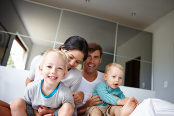 Oh no They wont let go. Shot of two young boys spending time indoors with their parents.
