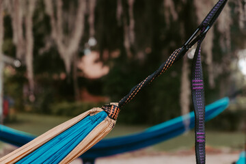 detail of yellow and blue hammock attachment in front of another hammock