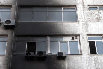 Burnt facade of building. Black walls after fire. Arson concept. Destroyed burned walls after fire...