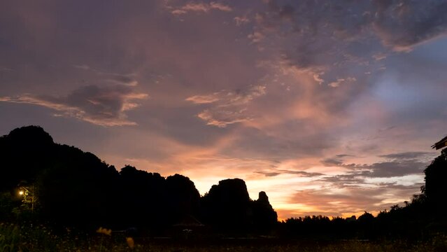 Beautiful dusk scenic sunset with rays of sun shining through dramatic clouds 4K ProRes UHQ Timelapse