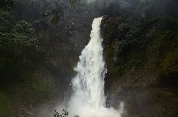Fototapeta na wymiar Fast waterfall flowing from rocky slope