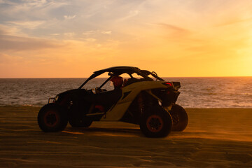 Buggy running on the beach at sunset - Powered by Adobe