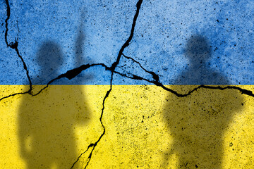 Flag of Ukraine painted on a concrete wall with russian soldiers. Relationship between Ukraine and...