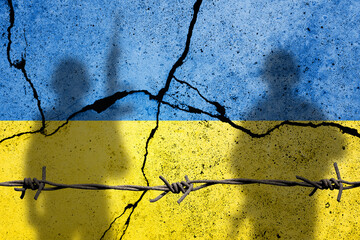 Flag of Ukraine painted on a concrete wall with russian soldiers. Relationship between Ukraine and...