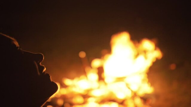 Silhouette of mystic woman in black background of fire fly flame, spark, of contour outline. Adult sexy of young girl witchcraft ceremony ritual dance in underclothes. Outdoor slow motion. Caucasian.