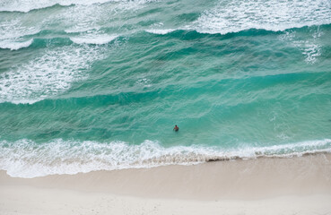 Beautiful view of Cristo Rei Backside Beach or known as Dolok Oan Beach in Dili, Timor Leste. Sea waves background. Aerial view of ocean waves.