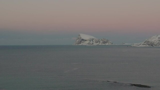 Snowy Unpopulated Haja Island With Dusk Gradient Sky In Norwegian Sea