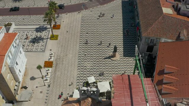 Topdown view along Cascais cidadela square, traditional Portuguese sidewalk pattern