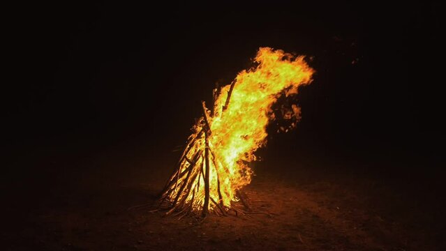 Silhouette of mystic woman in black background of fire fly flame, spark, of contour outline. Adult sexy of young girl witchcraft ceremony ritual dance in underclothes. Outdoor slow motion. Caucasian.
