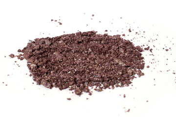 Scattered brown eye shadow isolated on a white background