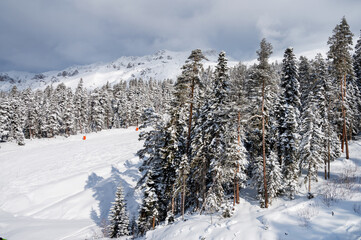 Beautiful landscape of the Arkhyz ski resort with mountains, snow and forest on a sunny winter day....