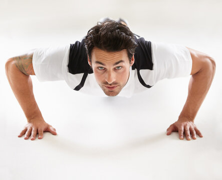 Getting His Body In Shape. Portrait Of A Young Man Doing Push-ups.