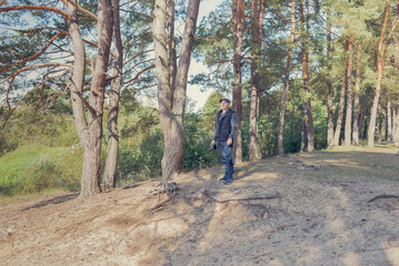 Fototapeta premium Man nature photographer taking pictures in the forest.