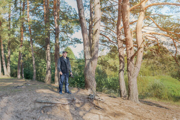 Fototapeta premium Man nature photographer taking pictures in the forest.