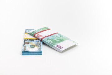 Obraz na płótnie Canvas Two Packs of European and US Banknotes Currencies Placed Together on White Background