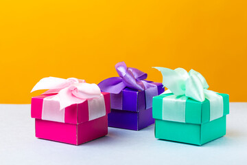 Wrapped Christmas and New Year Gifts of Various Colors Placed in Line on Yellow Blue  Background.