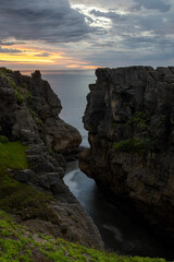 Fototapeta na wymiar Cliff pools sunset over the ocean