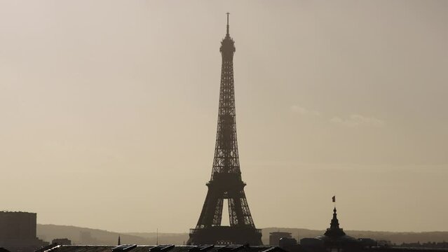 Beautiful view of Eiffel tower during golden hour with city haze Slow Motion 4k 30p