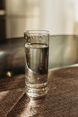 A glass of clean clear water stands on the table