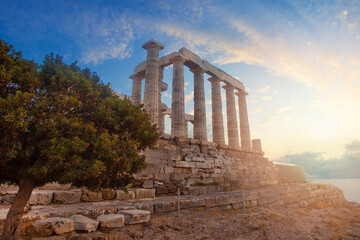 Greece. Cape Sounion - Ruins of an ancient Greek temple of Poseidon with sunset sky clouds