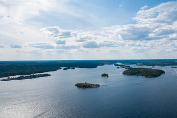 Aerial photography on Ladoga skerries. Ladoga Lake in Karelia in hot summer. Rocky wild islands in the middle of the lake. Russian nature