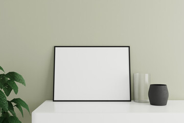 Minimalist and clean horizontal black poster or photo frame mockup on the white table leaning against the room wall with vase and plant