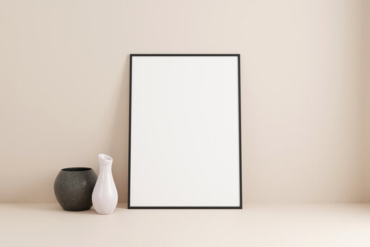 Minimalist vertical black poster or photo frame mockup on the floor leaning against the room wall