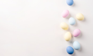 Pastel colored easter eggs on white background with copy space