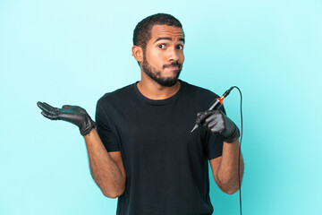 Tattoo artist Ecuadorian man isolated on blue background having doubts while raising hands