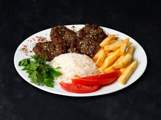 Meatballs Potatoes Rice on a Dark Background, White Plate
