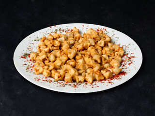 Traditional Turkish Crispy Ravioli Pasty and black background