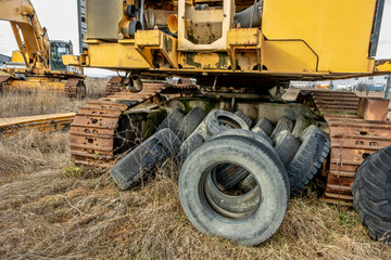 Fototapeta na wymiar crawler excavator and truck tires abandoned
