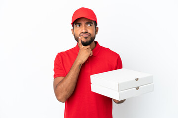 pizza delivery man picking up pizza boxes isolated on white background having doubts while looking...