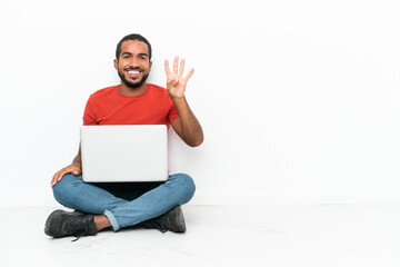Young Ecuadorian man with a laptop sitting on the floor isolated on white background happy and counting four with fingers
