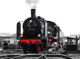 Steam Locomotive &ldquo;Br 38&ldquo; on a historic turntable in Ruhr Basin Germany, ready to leave the depot with historic coaches of &ldquo;Ruhrtalbahn&ldquo; in Ruhr valley. Black and white greyscale with colored elements.