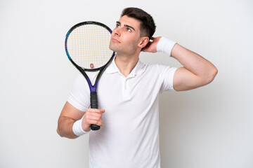 young tennis player man isolated on white background having doubts