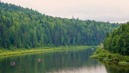 Calm river in the mountains. Aerial view of the river, flowing in the Ural Mountains among the impenetrable forest.