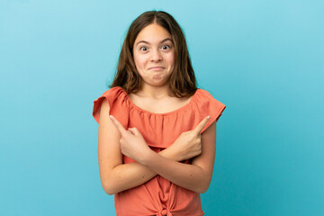 Little caucasian girl isolated on blue background pointing to the laterals having doubts